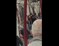 Guy slicks back hair on train 