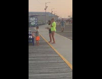 Two girls tiktok dance beach boardwalk bench 