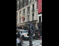 Guy white mask black bandana rock trump 