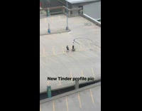 Guy arms raised rooftop parking lot 