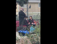 Two women formal attire sit bench act 