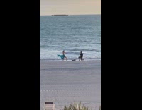Woman blue dress dance windy beach waves 