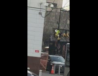 High school band plays song on to of double decker bus