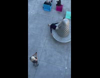 Old man takes pictures upside down on art bench