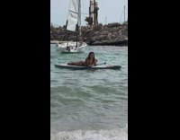Woman shades bikini sit paddle board beach