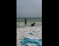 Woman jacket purple cap sit on beach