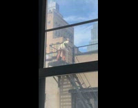 Girl poses black fire escape green purse