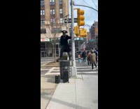 Guy standing on trash can blasts music  