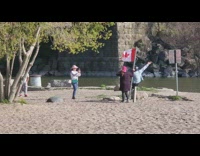 Two girls canadian flag beach pink hat 