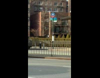 Guy rides tall unicycle on bike lane