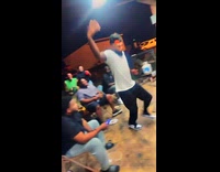 Man holds electric wire inside horse cage