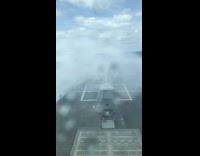 Blue ocean water hits grey boat 