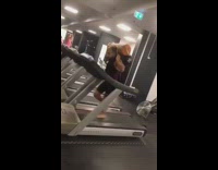 Guy runs on treadmill with weights 