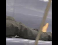 Guy laying down takes shoes off subway