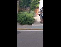 Woman white bikini use payphone on street