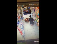 Security camera customer pours drink on employee