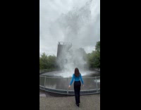 Woman watching water drop at science museum