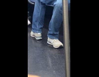 Man sit ride train feet face sideways