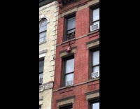 Person pull rope tied bag up the window