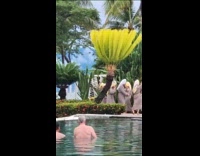 Women in bathrobes dances by the pool