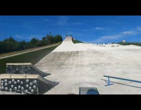 Guy snowboards down ramp 