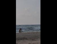 Woman in bikini sit and lie down on the beach shore