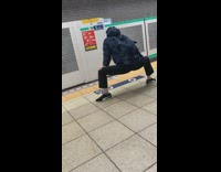 Man has legs wide open bent down