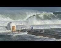 Two guys almost get hit large waves 