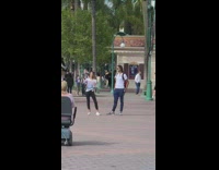 Woman vlogs disneyland  striped white shirt 