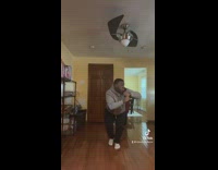 Guy grey hoodie walks through house sneaky 