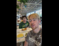 Guy at ikea eating mac and cheese with friend 