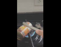 Trying to pick up can cooking on stove drops it tongs