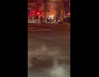 Sewage or gas line fire on the street with a car engulfed on fire 

