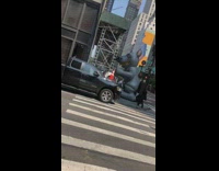 large rat inflatable next to casket on street