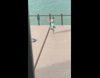 Woman dress spin hula hoop tricks beach part 2