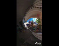 Teen Walks Around as  He Hold a 360 Camera