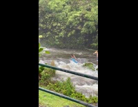 Woman in a mermaid costume in front of the waterfalls