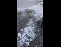 Man Drops Block of Frozen Snow on Ground