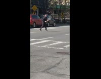 Guy stands in street plays tennis alone