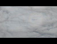 Halo and airplane shadow on the clouds