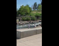 Guy girl jump river black shorts