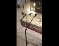 Black jacket snow angel sidewalk night time 
