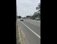Black Topless Car Drives Down Highway With Unsecured Wood Board