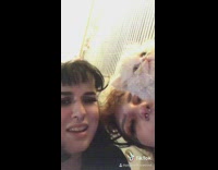 Girl with little white cat biting her finger