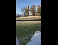 White pants girl sits sand volleyball net 