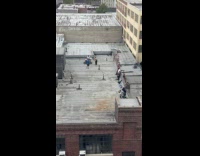 Video shoot man play drums on rooftop
