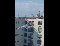Girl on wood swing white building rooftop 
