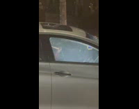 Guy smoking shisha at traffic light inside car