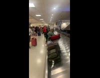 Womans luggage opens up after pulled from baggage claim