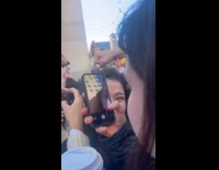 Crowd gets hyped films guy while walking